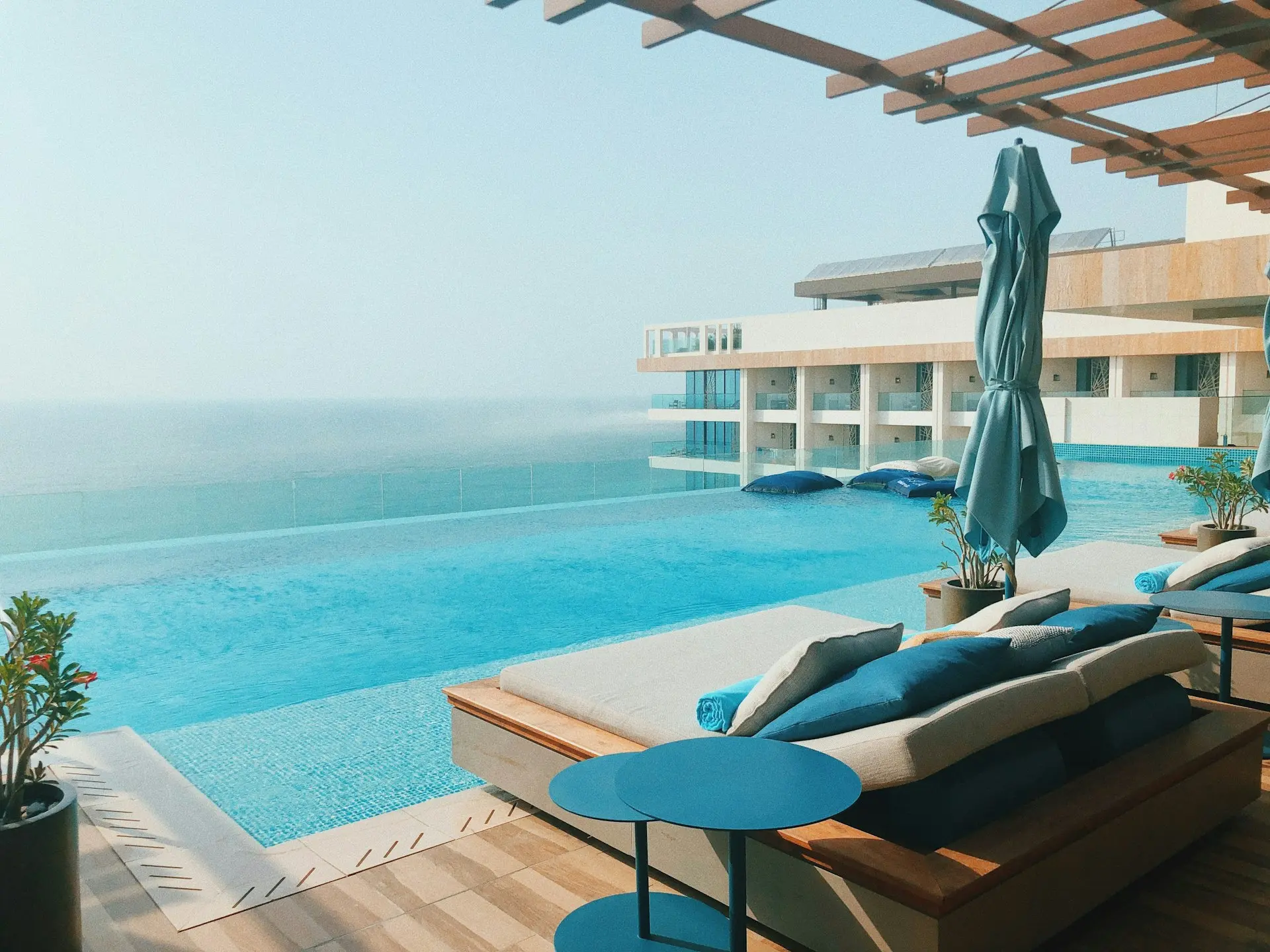 brown wooden lounge chairs near body of water during daytime